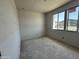 Bedroom featuring large window, smooth grey concrete flooring and grey unfinished walls at 2356 E Spur Dr, San Tan Valley, AZ 85140