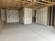 Unfinished two-car garage with concrete flooring, insulation, and a doorway to the home at 2370 E Spur Dr, San Tan Valley, AZ 85140