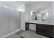 Spacious bathroom with vanity, and a shower with white shower curtain providing a bright and clean atmosphere at 25457 W Clanton Ave, Buckeye, AZ 85326