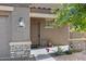 Inviting front entrance with decorative plants and covered porch at 25457 W Clanton Ave, Buckeye, AZ 85326