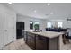 The kitchen has a spacious island, tile floors, and dark wood cabinets at 25457 W Clanton Ave, Buckeye, AZ 85326
