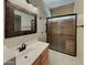 Updated bathroom featuring granite counters, decorative mirror, and a glass-enclosed shower at 2600 E La Costa Dr, Chandler, AZ 85249