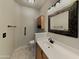 Cozy bathroom with an ornate framed mirror, great lighting, and updated fixtures at 2600 E La Costa Dr, Chandler, AZ 85249