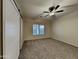 Neutral bedroom features plush carpeting, a barn door, and a ceiling fan at 2600 E La Costa Dr, Chandler, AZ 85249