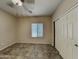 Cozy bedroom offers neutral tones, a ceiling fan and a closet at 2600 E La Costa Dr, Chandler, AZ 85249