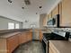 Open concept kitchen area features stainless steel appliances, tile flooring, and ample counter space at 2600 E La Costa Dr, Chandler, AZ 85249