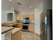 Well-equipped kitchen features stainless steel appliances, light wood cabinets, and tile backsplash at 2600 E La Costa Dr, Chandler, AZ 85249