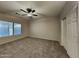 Spacious main bedroom with a ceiling fan, closet and window at 2600 E La Costa Dr, Chandler, AZ 85249