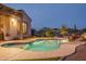 Backyard pool at dusk, set among desert landscape and a relaxing outdoor seating area at 26673 W Ponderosa Ln, Buckeye, AZ 85396