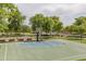 Community basketball court surrounded by mature trees and green spaces at 26673 W Ponderosa Ln, Buckeye, AZ 85396