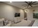 Comfortable bedroom featuring soft colors, carpeted floors, ceiling fan, and sitting area at 26673 W Ponderosa Ln, Buckeye, AZ 85396