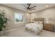Serene bedroom featuring neutral tones, plush bedding, modern ceiling fan, and a window with plantation shutters at 26673 W Ponderosa Ln, Buckeye, AZ 85396