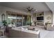 Inviting covered patio with stylish furniture, fireplace, and scenic views through the sliding glass doors at 26673 W Ponderosa Ln, Buckeye, AZ 85396