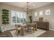 Inviting dining room with a stylish chandelier, comfortable seating, and abundant natural light at 26673 W Ponderosa Ln, Buckeye, AZ 85396