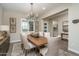 Bright dining area showcasing stylish light fixture and serene decor at 26673 W Ponderosa Ln, Buckeye, AZ 85396