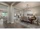 Elegant dining room with modern chandelier and furniture, open to living spaces at 26673 W Ponderosa Ln, Buckeye, AZ 85396