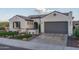 Stunning desert home with gray tile roof, landscaped yard, and inviting front entrance at 26673 W Ponderosa Ln, Buckeye, AZ 85396