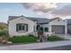 Charming home exterior with arched entry, neat landscaping, and well-lit walkway at 26673 W Ponderosa Ln, Buckeye, AZ 85396