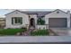 Desert home exterior with gray tile roof, landscaped yard, and inviting front entrance at 26673 W Ponderosa Ln, Buckeye, AZ 85396