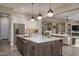 Spacious kitchen with a large center island, stainless steel appliances, and open layout to the living area at 26673 W Ponderosa Ln, Buckeye, AZ 85396