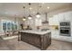 Bright kitchen with a center island, stainless steel appliances, and easy access to the dining area at 26673 W Ponderosa Ln, Buckeye, AZ 85396