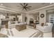 Bright living room featuring comfortable seating, stylish decor, and seamless flow into adjacent dining and kitchen areas at 26673 W Ponderosa Ln, Buckeye, AZ 85396