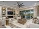 Comfortable living room featuring a fireplace, large TV, and access to the patio at 26673 W Ponderosa Ln, Buckeye, AZ 85396