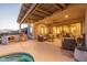 Covered patio with modern furniture, an outdoor kitchen, ceiling fan, and seamless indoor-outdoor living at 26673 W Ponderosa Ln, Buckeye, AZ 85396