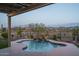 Scenic backyard pool area, highlighted by a waterfall feature and desert landscaping at 26673 W Ponderosa Ln, Buckeye, AZ 85396