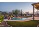 Relaxing backyard pool and spa with outdoor seating, lush desert landscape, and scenic mountain views at 26673 W Ponderosa Ln, Buckeye, AZ 85396