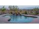 Close up of a luxurious pool featuring a rock waterfall and beautiful, cool water at 26673 W Ponderosa Ln, Buckeye, AZ 85396