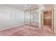 Bedroom features a ceiling fan, mirrored closet doors, and a door to hallway at 3031 N Civic Center Plz # 112, Scottsdale, AZ 85251