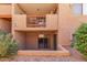 Condo exterior features a small patio with rock landscaping and a privacy screen for each unit at 3031 N Civic Center Plz # 112, Scottsdale, AZ 85251