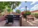 Community grill and seating area with mature landscaping at 3031 N Civic Center Plz # 112, Scottsdale, AZ 85251