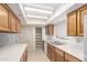 Functional kitchen features wood cabinets, white countertops, ample storage space, and modern appliances at 3031 N Civic Center Plz # 112, Scottsdale, AZ 85251