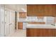 Bright kitchen features wood cabinets, laminate countertops, and a white appliance package at 3031 N Civic Center Plz # 112, Scottsdale, AZ 85251