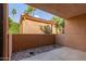 Enclosed patio features rock landscaping, stucco walls, and views of trees at 3031 N Civic Center Plz # 112, Scottsdale, AZ 85251