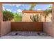 Enclosed patio features rock landscaping, stucco walls, and views of trees at 3031 N Civic Center Plz # 112, Scottsdale, AZ 85251