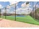 Community tennis court with green and blue surface, surrounded by fencing and landscaping at 3031 N Civic Center Plz # 112, Scottsdale, AZ 85251