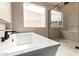 Bathroom featuring a modern soaking tub and glass enclosed shower with dark hardware at 33857 N Borgata Trl, San Tan Valley, AZ 85144