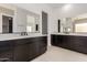 Modern bathroom featuring dual vanities with dark cabinets, light countertops, and large mirrors at 33857 N Borgata Trl, San Tan Valley, AZ 85144