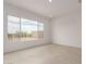 Bright bedroom with large windows and tile flooring, offering serene views at 33857 N Borgata Trl, San Tan Valley, AZ 85144