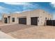 Modern home featuring a large two-car garage and desert landscaping in a serene setting at 33857 N Borgata Trl, San Tan Valley, AZ 85144
