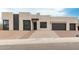 Contemporary home with a modern architectural style with integrated two car garage and desert landscaping at 33857 N Borgata Trl, San Tan Valley, AZ 85144