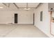 Spacious three car garage with smooth concrete floors, neutral walls, and dark accent doors at 33857 N Borgata Trl, San Tan Valley, AZ 85144