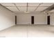 Spacious three car garage with smooth concrete floors and dark accent doors at 33857 N Borgata Trl, San Tan Valley, AZ 85144