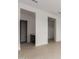 Hallway featuring neutral tile floors leading to doorways and open areas, with modern trim and paint at 33857 N Borgata Trl, San Tan Valley, AZ 85144