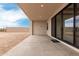 Outdoor patio with large sliding glass doors to the house and a retaining wall at 33857 N Borgata Trl, San Tan Valley, AZ 85144