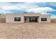 Modern home exterior featuring clean lines, large windows, and a covered patio, surrounded by a gravel yard at 33857 N Borgata Trl, San Tan Valley, AZ 85144