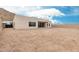 The rear exterior of a modern, single-story home with a minimalist design and a spacious gravel yard at 33857 N Borgata Trl, San Tan Valley, AZ 85144